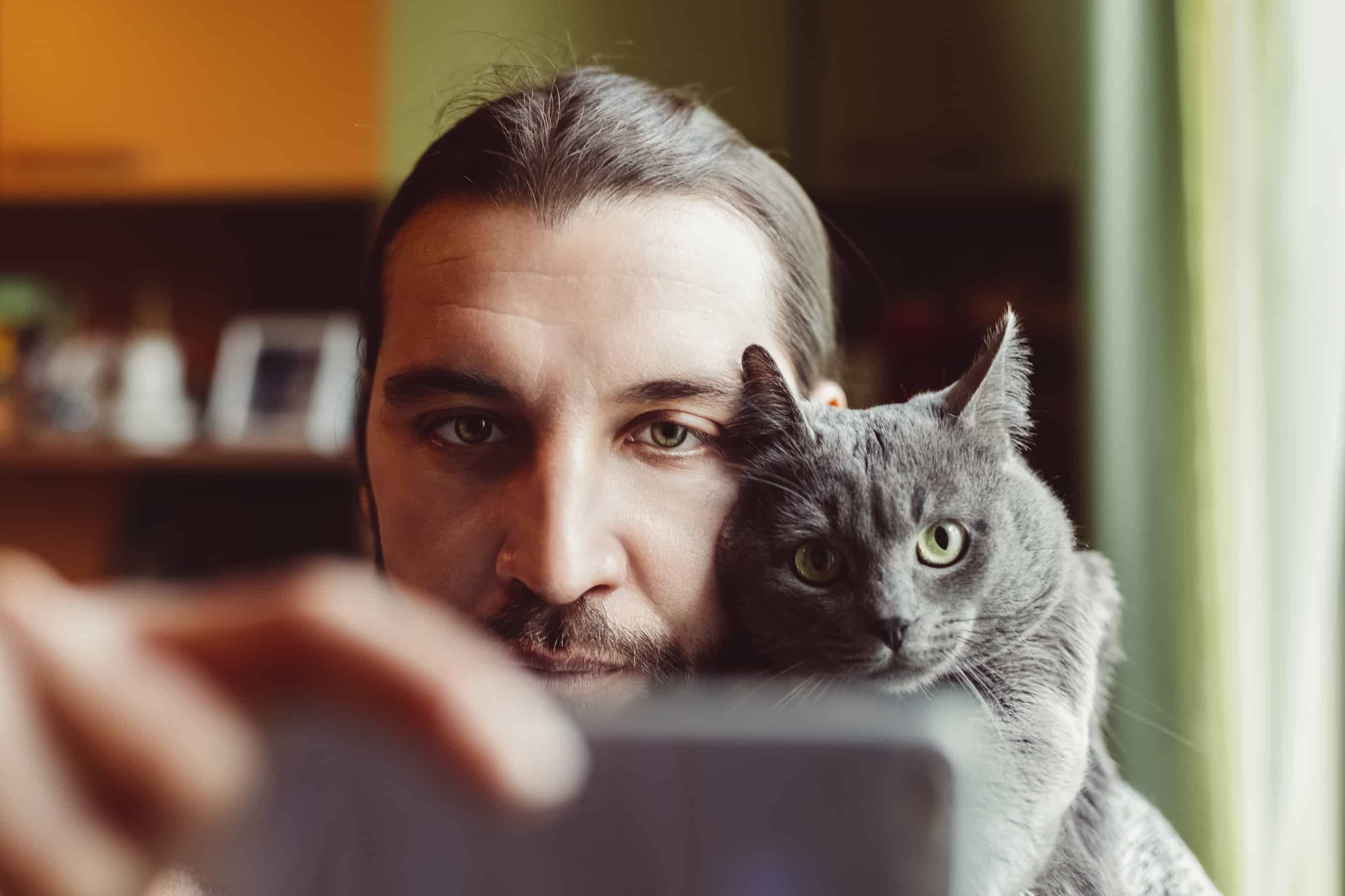 Man and cat taking selfie