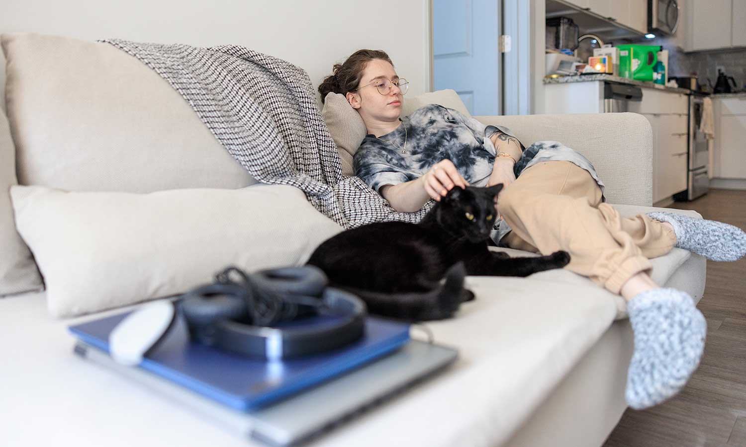 A black cat with their human